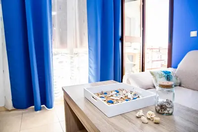 a room with a table with a box of shells on it at VALDECARRETAS Apartamento Rota cerca de playa in Rota