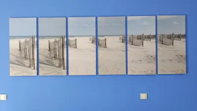 four pictures of a beach with fences in the sand at VALDECARRETAS Apartamento Rota cerca de playa in Rota