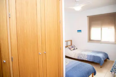 a bedroom with a closet and a bed in it at VALDECARRETAS Apartamento Rota cerca de playa in Rota