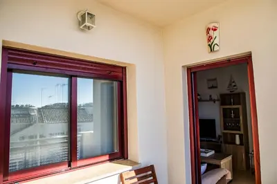 a room with a window with a view of a balcony at VALDECARRETAS Apartamento Rota cerca de playa in Rota