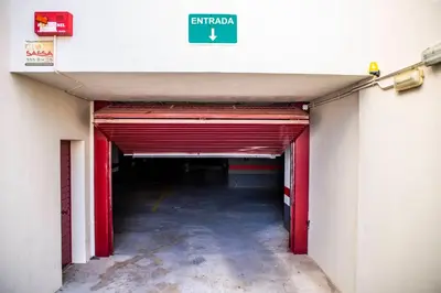 a hallway of a parking garage with a exit sign at VALDECARRETAS Apartamento Rota cerca de playa in Rota