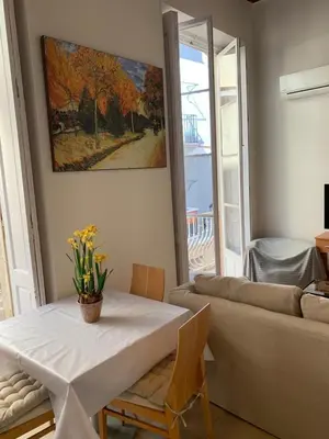 a living room with a table and a couch at Apartamentos Valverde Cádiz 1 - A in Cádiz