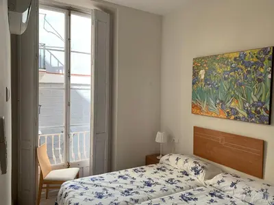a bedroom with a bed and a painting on the wall at Apartamentos Valverde Cádiz 1 - A in Cádiz