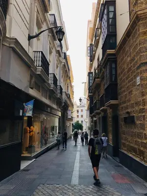 a group of people walking down a street with buildings at Apartamentos Valverde Cádiz 1 - A in Cádiz