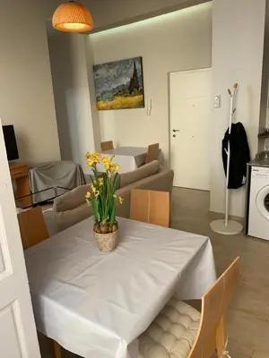 a living room with a white table with flowers on it at Apartamentos Valverde Cádiz 1 - A in Cádiz