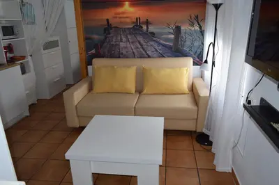 a living room with a couch and a table at LOS TOCHOS in Chiclana de la Frontera