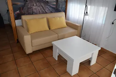 a living room with a couch and a table at LOS TOCHOS in Chiclana de la Frontera