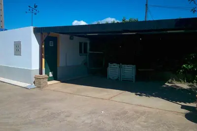a building with a garage with two chairs in it at Bright House in Sanlúcar – Fireplace in Sanlúcar de Barrameda