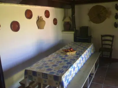 a table in a room with plates on the wall at Bright House in Sanlúcar – Fireplace in Sanlúcar de Barrameda
