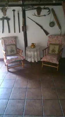 a living room with two chairs and a table at Bright House in Sanlúcar – Fireplace in Sanlúcar de Barrameda