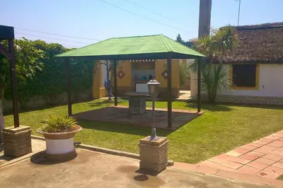 a gazebo with a green roof in a yard at Bright House in Sanlúcar – Fireplace in Sanlúcar de Barrameda