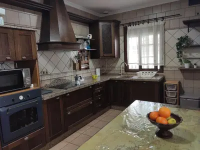 a kitchen with a bowl of fruit on a counter at Chalet Santi Playa de la Barrosa in Chiclana de la Frontera