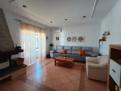 a living room with a couch and a table at Chalet Santi Playa de la Barrosa in Chiclana de la Frontera