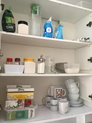 a kitchen pantry with shelves filled with dishes and cups at La terraza de San Pedro in Cádiz