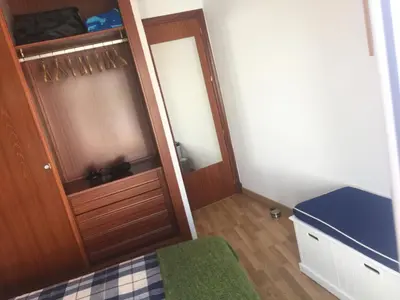 a bedroom with a wooden door and a bed and a mirror at La terraza de San Pedro in Cádiz