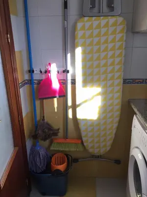 a lamp in a kitchen next to a washing machine at La terraza de San Pedro in Cádiz