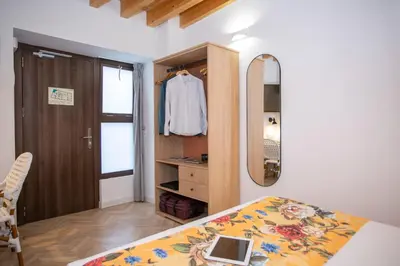 a bedroom with a bed and a mirror and a closet at Casual con Duende Cadiz in Cádiz