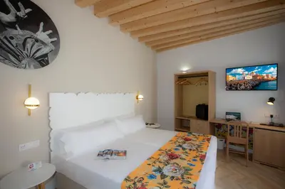 a bedroom with a bed and a tv on the wall at Casual con Duende Cadiz in Cádiz