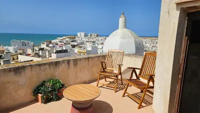 two chairs and a table on a balcony with a view at Casual con Duende Cadiz in Cádiz