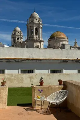a patio with a table and a chair on a building at Casual con Duende Cadiz in Cádiz