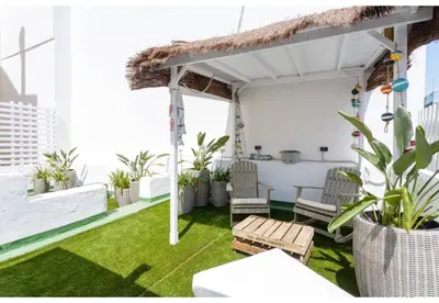 a patio with grass and plants on a building at TERRAZA-Caleta Beach Home by Cadiz4Rentals in Cádiz