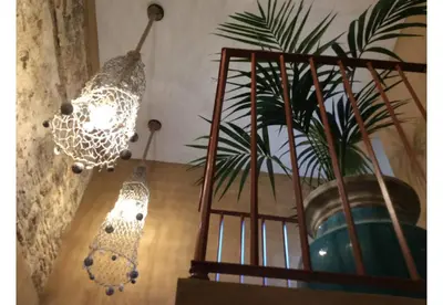 two lights hanging from a wall with a potted plant at TERRAZA-Caleta Beach Home by Cadiz4Rentals in Cádiz