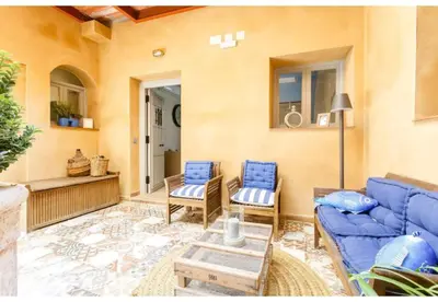 a living room with a blue couch and chairs at PATIO-Caleta Beach Home by Cadiz4Rentals in Cádiz