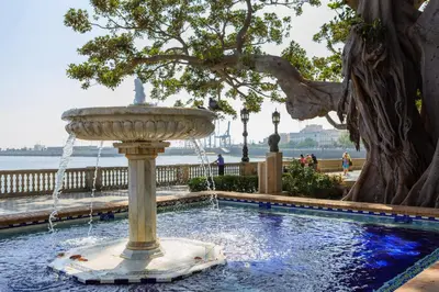 a fountain in a park with a tree and water at PATIO-Caleta Beach Home by Cadiz4Rentals in Cádiz