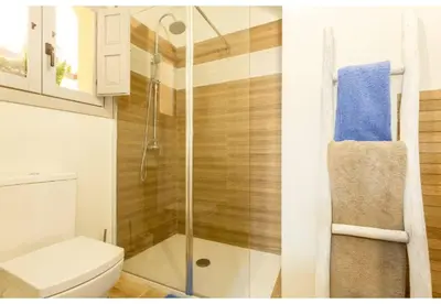 a bathroom with a toilet and a glass shower at PATIO-Caleta Beach Home by Cadiz4Rentals in Cádiz
