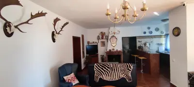 a living room with a zebra chair and a table at Casa Rural El Romeral in Medina Sidonia