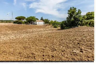 a large field with a house on top of it at Casa Rural El Romeral in Medina Sidonia
