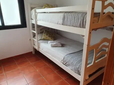 a room with bunk beds in a hostel at Coto la Campa in Chiclana de la Frontera