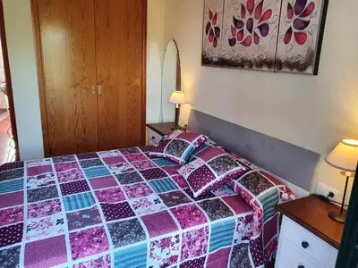 a bedroom with a bed with a colorful quilt at Coto la Campa in Chiclana de la Frontera