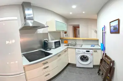 a kitchen with a sink and a washer at Apartamento Plaza Viuda in Cádiz