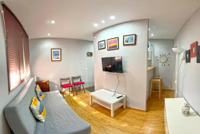 a living room with a couch and a table at Apartamento Plaza Viuda in Cádiz