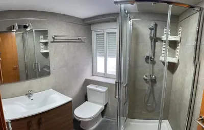 a bathroom with a shower and a toilet and a sink at Apartamento Plaza Viuda in Cádiz