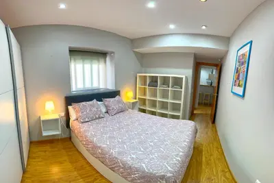 a bedroom with a large bed in a room at Apartamento Plaza Viuda in Cádiz