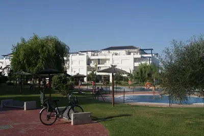 a bike parked in a park next to a pool at Apartamento en Bahia Golf - Costa Ballena in Costa Ballena