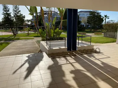 a group of benches sitting in a park at Apartamento en Bahia Golf - Costa Ballena in Costa Ballena