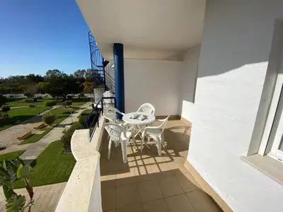 a balcony of a house with a table and chairs at Apartamento en Bahia Golf - Costa Ballena in Costa Ballena