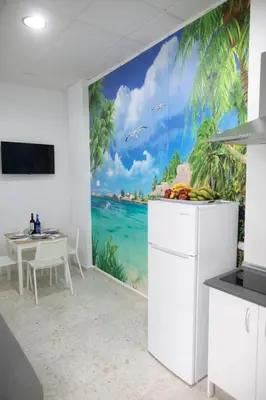 a kitchen with a mural of the ocean and palm trees at Miriam Costa de la luz in Jerez de la Frontera