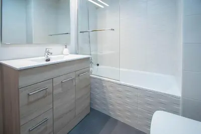 a bathroom with a sink and a shower and a tub at Duplex Flamingo Cadiz in Cádiz