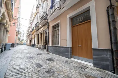 an empty street in a city with buildings at Duplex Flamingo Cadiz in Cádiz