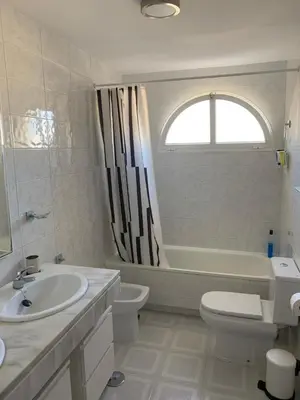 a bathroom with a sink and a toilet and a tub at VIVE JEREZ Casa de lujo con piscina y barbacoa en la mejor zona de Jerez de la Frontera in Jerez de la Frontera