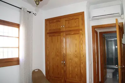 a room with a wooden closet and a door at Apartamento Playa de Regla, Aire acondicionado, Garaje in Chipiona