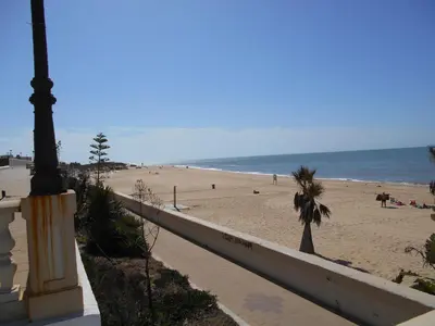 a view of a beach with a pole and the ocean at Apartamento Playa de Regla, Aire acondicionado, Garaje in Chipiona