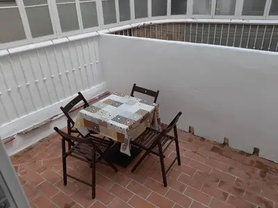 a table and two chairs on a brick patio at Apartamentos Valverde Cádiz 1-C in Cádiz