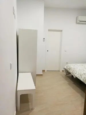a white room with a bed and a mirror at Apartamentos Valverde Cádiz 1-C in Cádiz