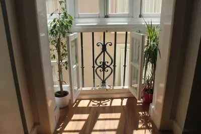 an entrance to a house with a gate and plants at Bonito apartamento Cádiz centro in Cádiz