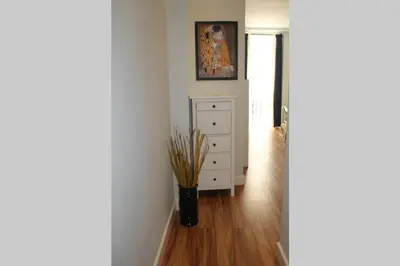 a hallway with a white dresser and a vase with sticks at Bonito apartamento Cádiz centro in Cádiz